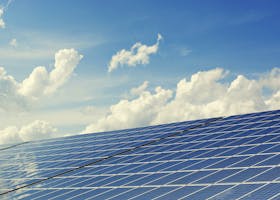 pexels photo 356036 356036 Sleek modern solar panels under a vibrant blue sky with clouds, symbolizing clean energy.